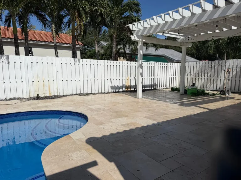 White wood fence around a pool patio