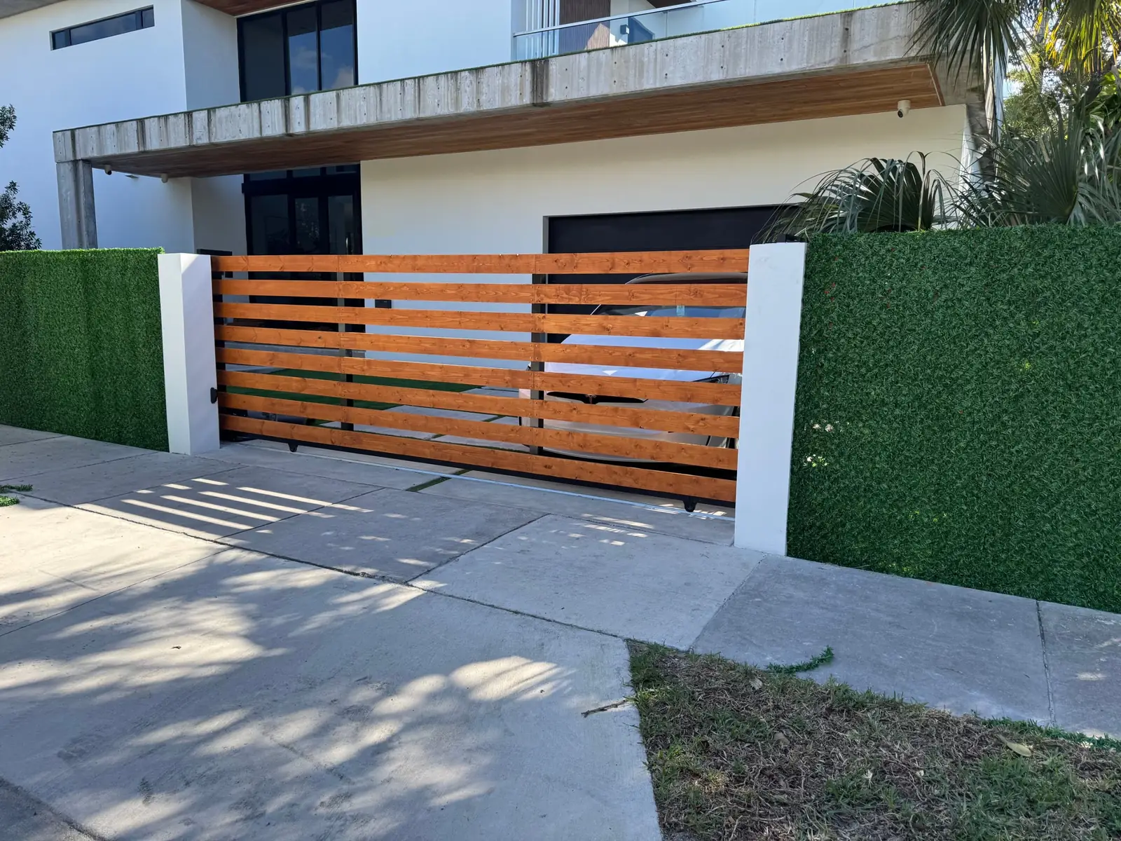 Dolce Green artificial grass fence on a modern home gate in South Florida